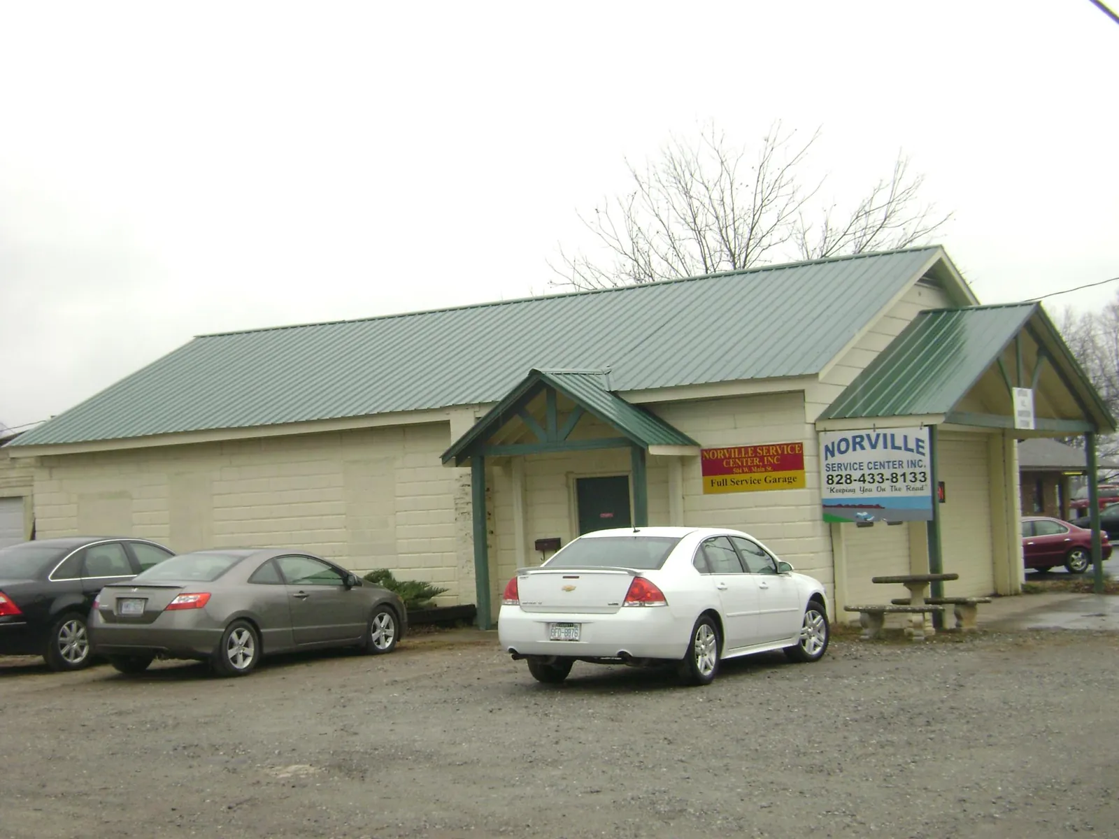 Green metal roof on a service garage with a covered entry in Turtle Lake